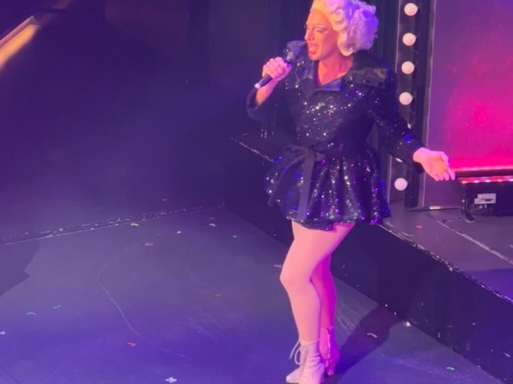 Virgin Voyages Diva performing on stage during a live show at sea.