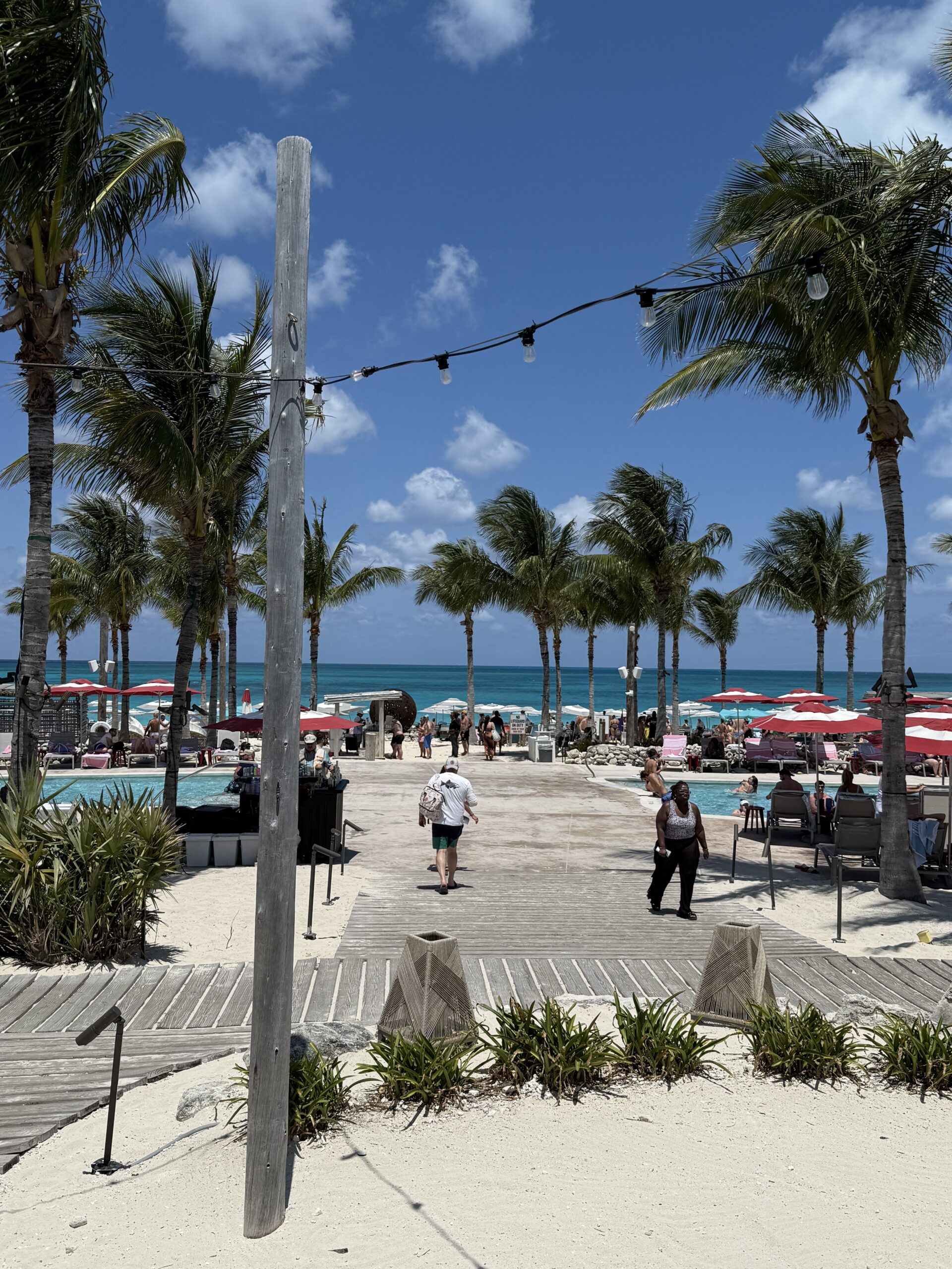 The Beach Club at Bimini on Virgin Voyages with palm trees, boardwalk and ocean views – what the beach club experience really looks like