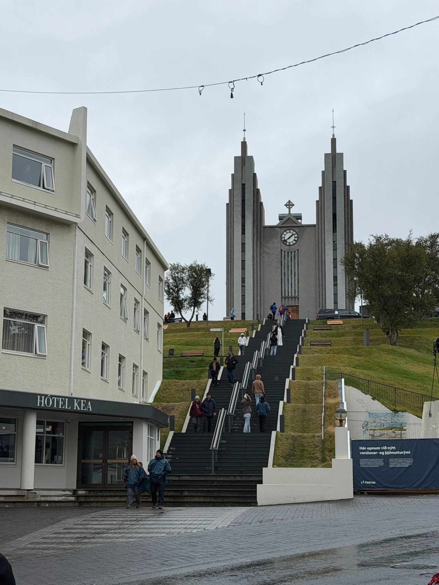 Akureyrarkirkja church overlooking the city centre of Akureyri, Iceland, with visitors climbing the famous staircase during a Virgin Voyages port visit.