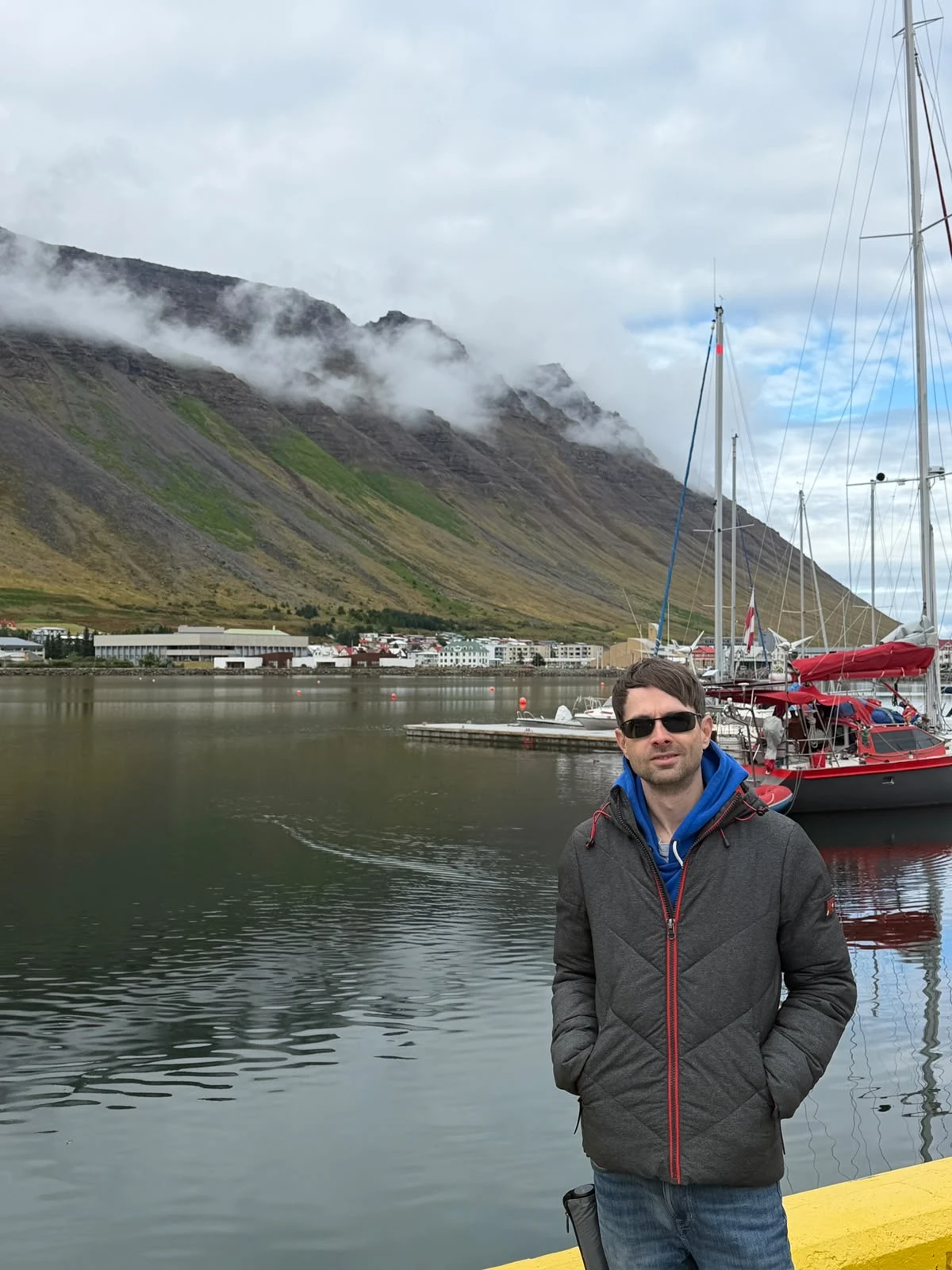 Scenic view of Ísafjörður, Iceland, featuring the harbour, sailboats and dramatic Westfjords mountains during a Virgin Voyages visit.