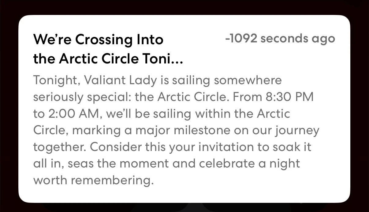 Virgin Voyages app notification announcing Valiant Lady's crossing of the Arctic Circle during a cruise voyage, displayed on a mobile device screen.