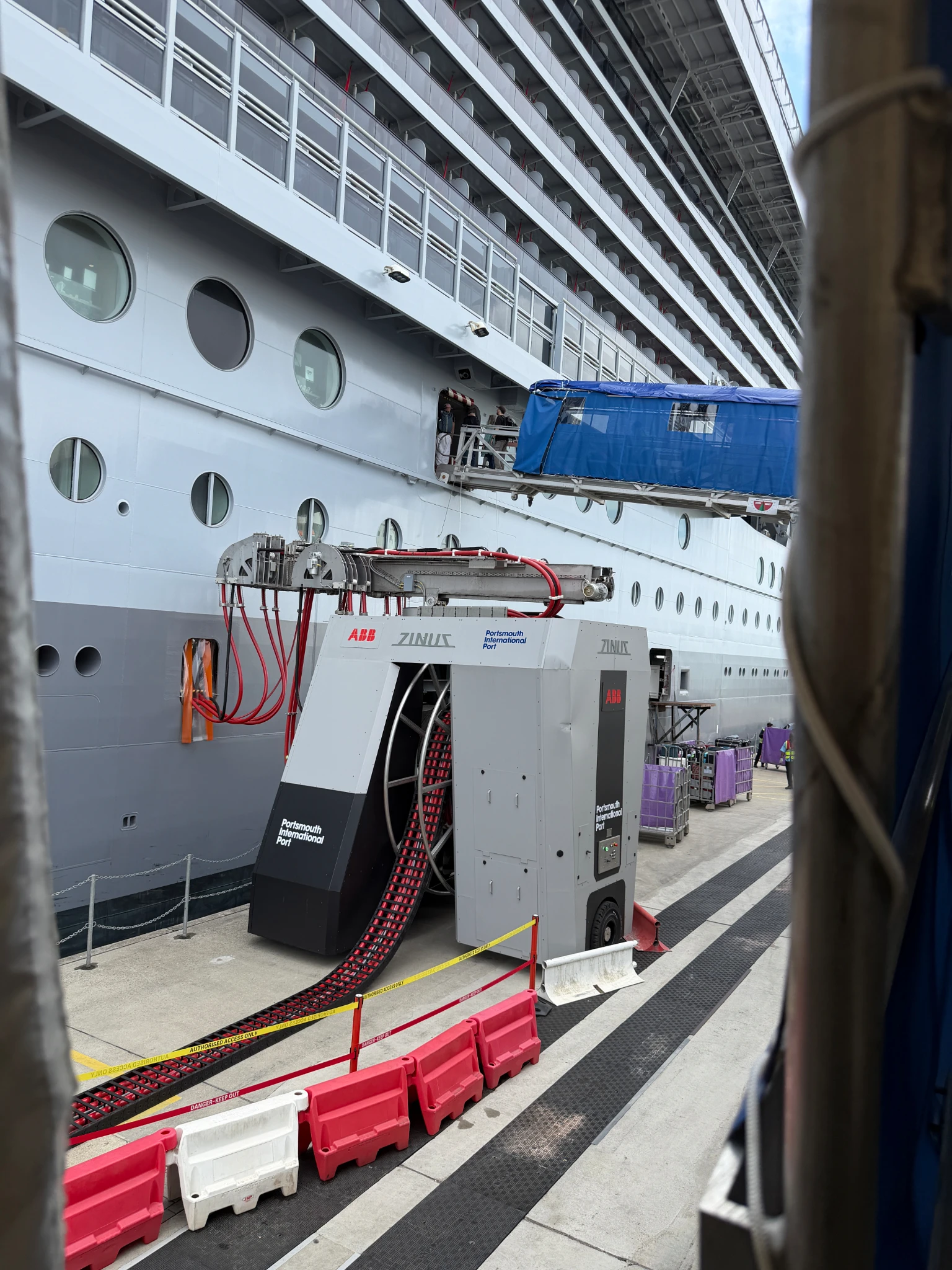 Onshore power supply equipment connected to a cruise ship alongside Portsmouth Cruise Terminal, supporting shore power operations while in port.