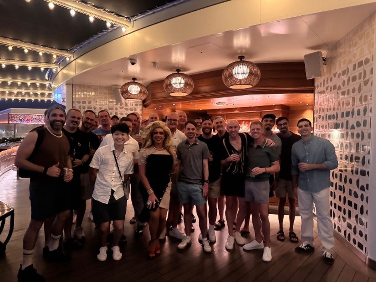 LGBT sailors attending a friendly meet‑up event onboard Virgin Voyages’ Valiant Lady.